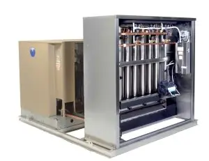 Skid-mounted Arctic-Temp® ice machine with its panel open showing evaporator tubes, beside a tan condensing unit