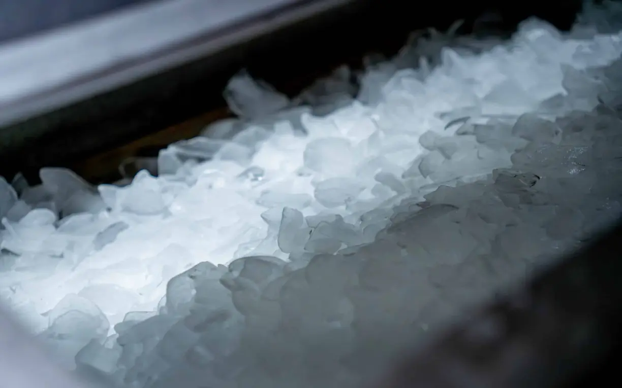 cracked ice machine Pile of hard cracked ice in a stainless steel bin